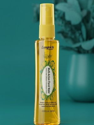 Yellow spray bottle with floral design on a teal background